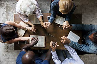 Group of people holding hands praying worship believe