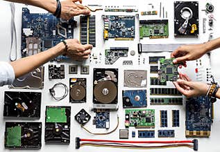 Aerial view of hands with computer electronics parts on white background