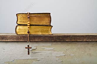 Rosary beads and books of Catholic Church liturgy