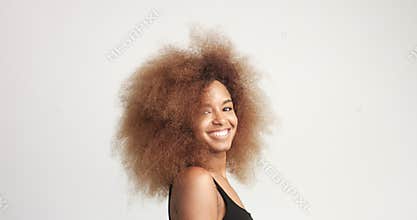 Beuayt black woman with a huge afro hair having fun smiling and touching her hair