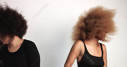 Couple of black womans with huge afro hair dancing and shaking heads