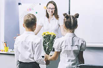 Beautiful children school children with flowers for the teachers