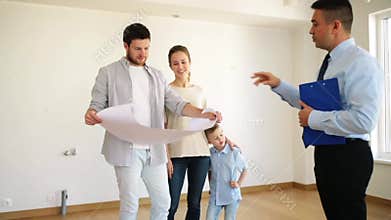 Happy family and realtor at new house or apartment