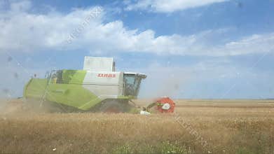 Combine harvester in field