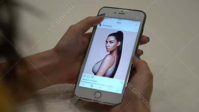 Samara, Russia - June 30, 2017: Woman looks instagram Kim Kardashian on your iPhone 6s Plus.