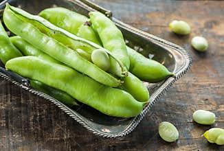 Fresh broad bean pods - closeup with selective focus