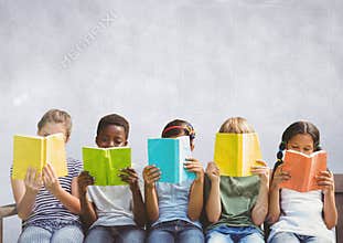 Group of children sitting and reading in front of grey background