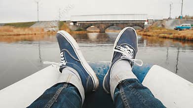 POV view of a tourist moving feet on the boat ride