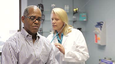 Doctor Listening To Patient's Breathing With Stethoscope