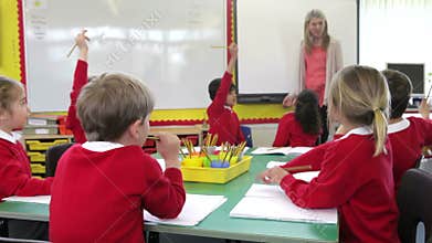 Pupils Sitting Around Table As Teacher Asks A Question