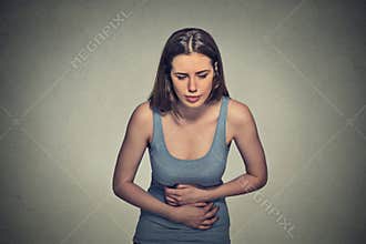Woman hands on stomach having bad aches pain