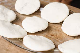 Tray of raw arepas.