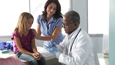 Mother And Child Visiting Doctor's Office