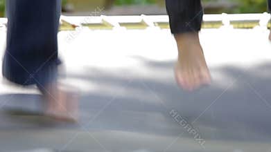 Close Up Of Children's Feet Jumping On Trampoline