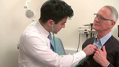 Doctor Listening To Senior Male Patient's Chest