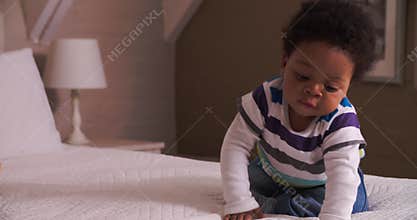 Cute Baby Having Fun Bouncing On Parents Bed