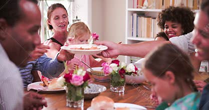 Group Of Families Having Meal At Home Together