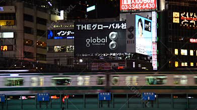 Passenger Train Passes the Shinjuku Skyline at Night - Tokyo Japan