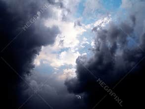 Blue sky behind stormy clouds