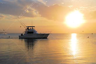 Boat going fishing at sunset