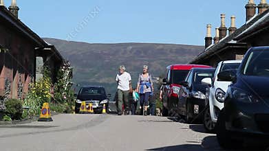 People walking in the streets of beautiful Luss, Scotland, UK, HD footage