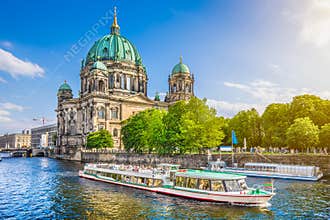Berlin Cathedral with boat on Spree river at sunset, Germany