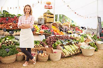 Female Stall Holder At Farmers Fresh Food Market