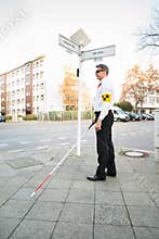 Blind Man Wearing Armband Crossing Road