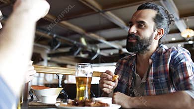 Happy male friends drinking beer at bar or pub