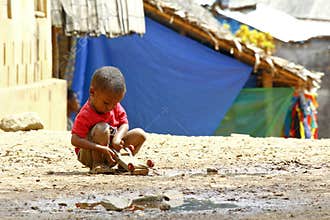Small African boy, outdoors, playing with a car