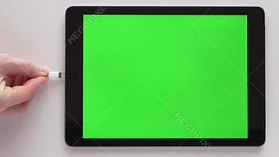 Charging cable plugging into iPad