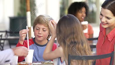 Family Enjoying Snack At Outdoor Cafï¿½