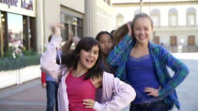 Group Of Teenage Children Posing For Camera In Slow Motion