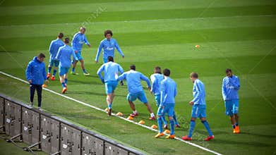 Football players doing dribbling exercise
