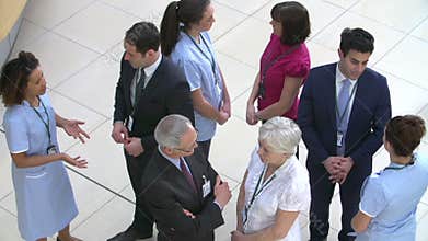 Overhead View Of Hospital Staff Meeting In Busy Reception