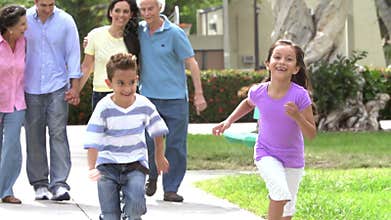 Slow Motion Shot Of Multi Generation Family Walking In Park