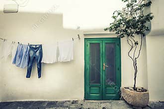 Italian vintage scene. Clothes hanging to dry and old house.