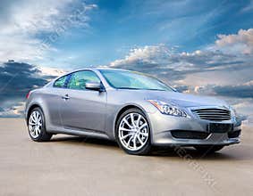 Luxury sports car against bright cloudy sky