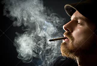 Bearded man smoking a cigar