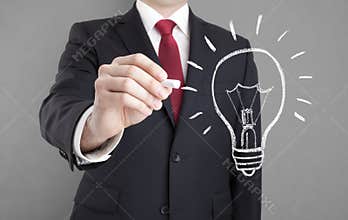 Businessman drawing idea light bulb