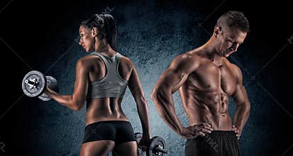 Athletic man and woman with a dumbells.