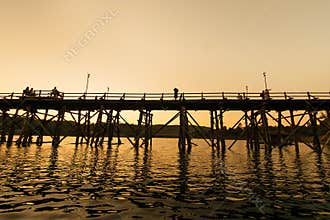 The silhouette of old wooden bridge Bridge collapse Bridge across the river and Wood bridge (Mon bridge ) at sangklaburi