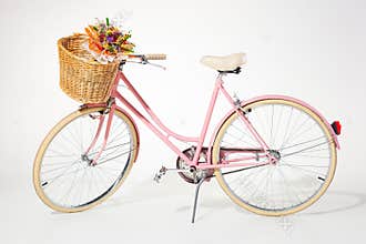 Pink vintage bicycle whith flower basket isolated on white backg