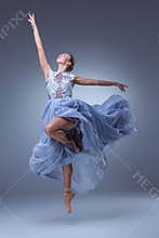 The beautiful ballerina dancing in blue long dress