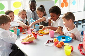 Group Of Children Eating Lunch In School Cafeteria