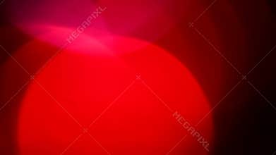 Moving red defocused lights through dark background.