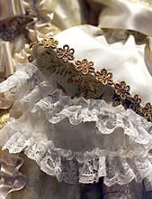 detail of an old wedding dress in ivory color with floral decorations