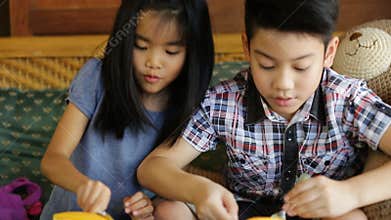 Happy asian child enjoy eating cake together