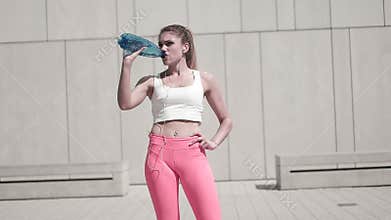 Fitness Woman drinking water on location