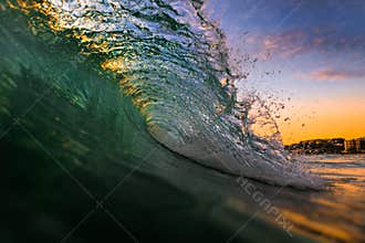 Ocean Wave Breaking at Sunset Sunrise